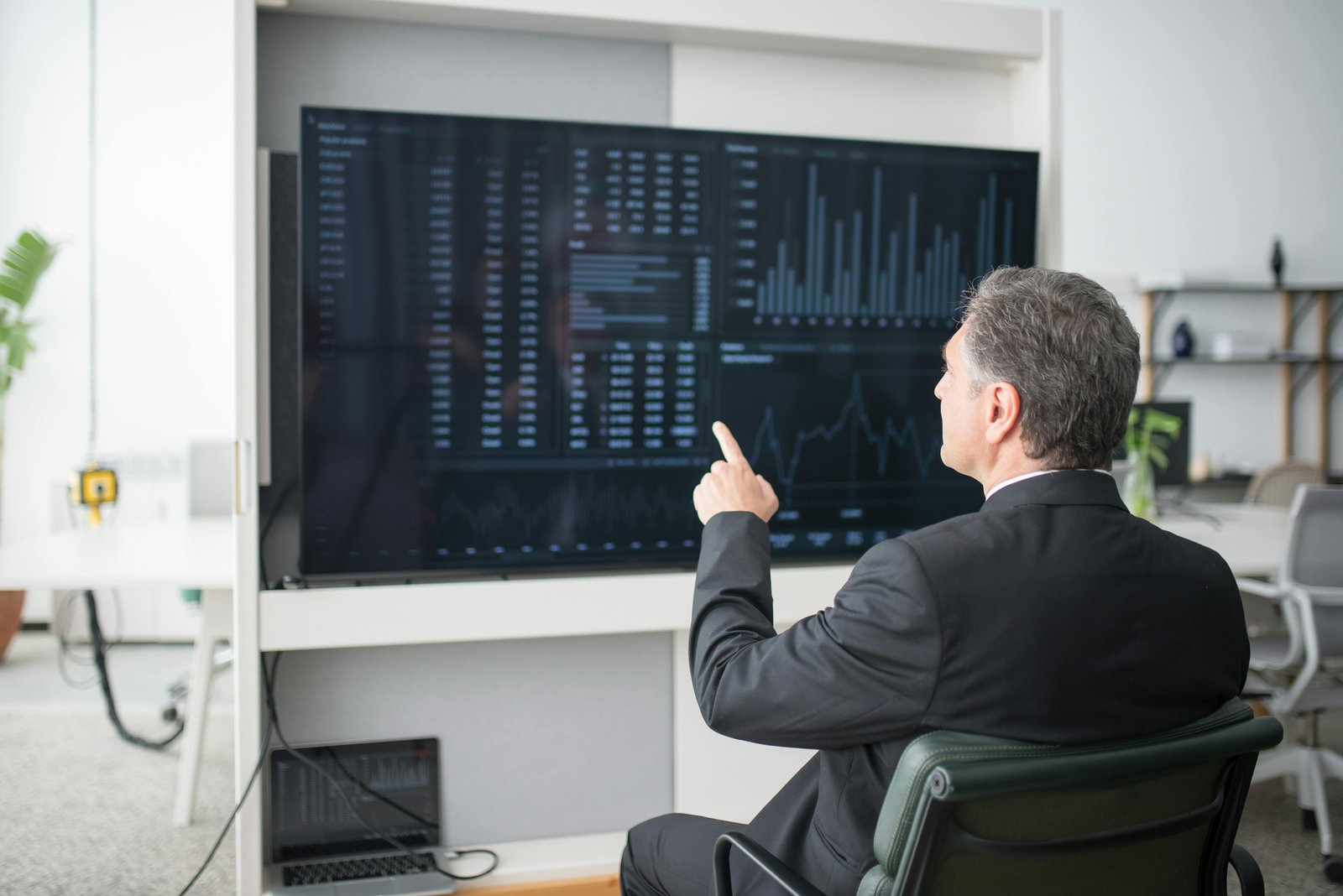 Business professional reviewing a dashboard on a large screen